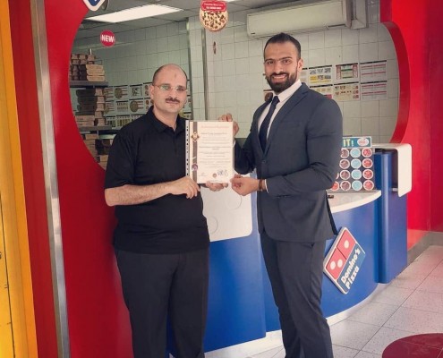 Domino’s Pizza country manager Mr. Salah Shawky (left) received the HACCP certificate from H.A. Consultancies business development associate Mr. Ammar Jameel